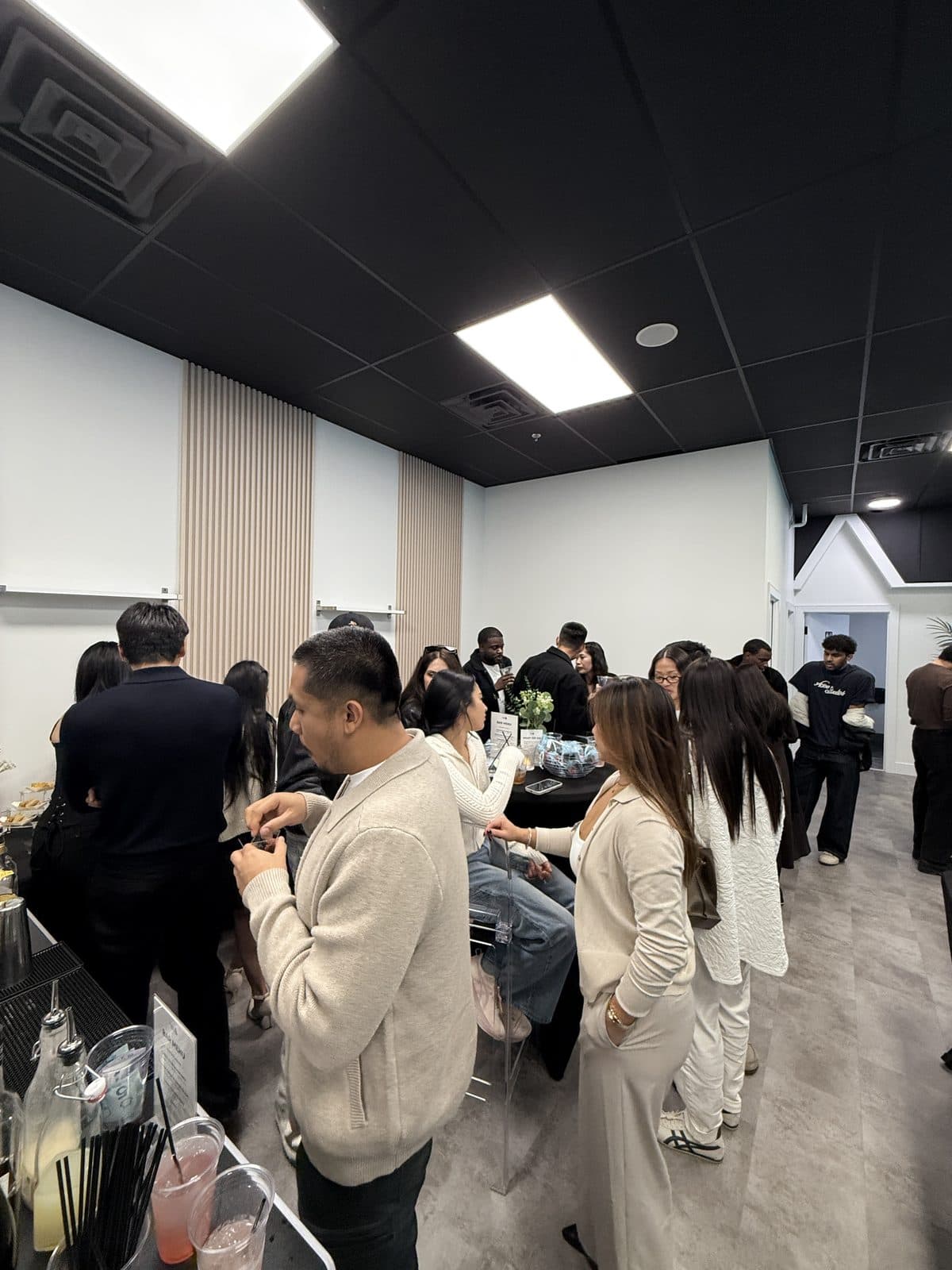 A crowded room of guests in the studio during the grand opening
