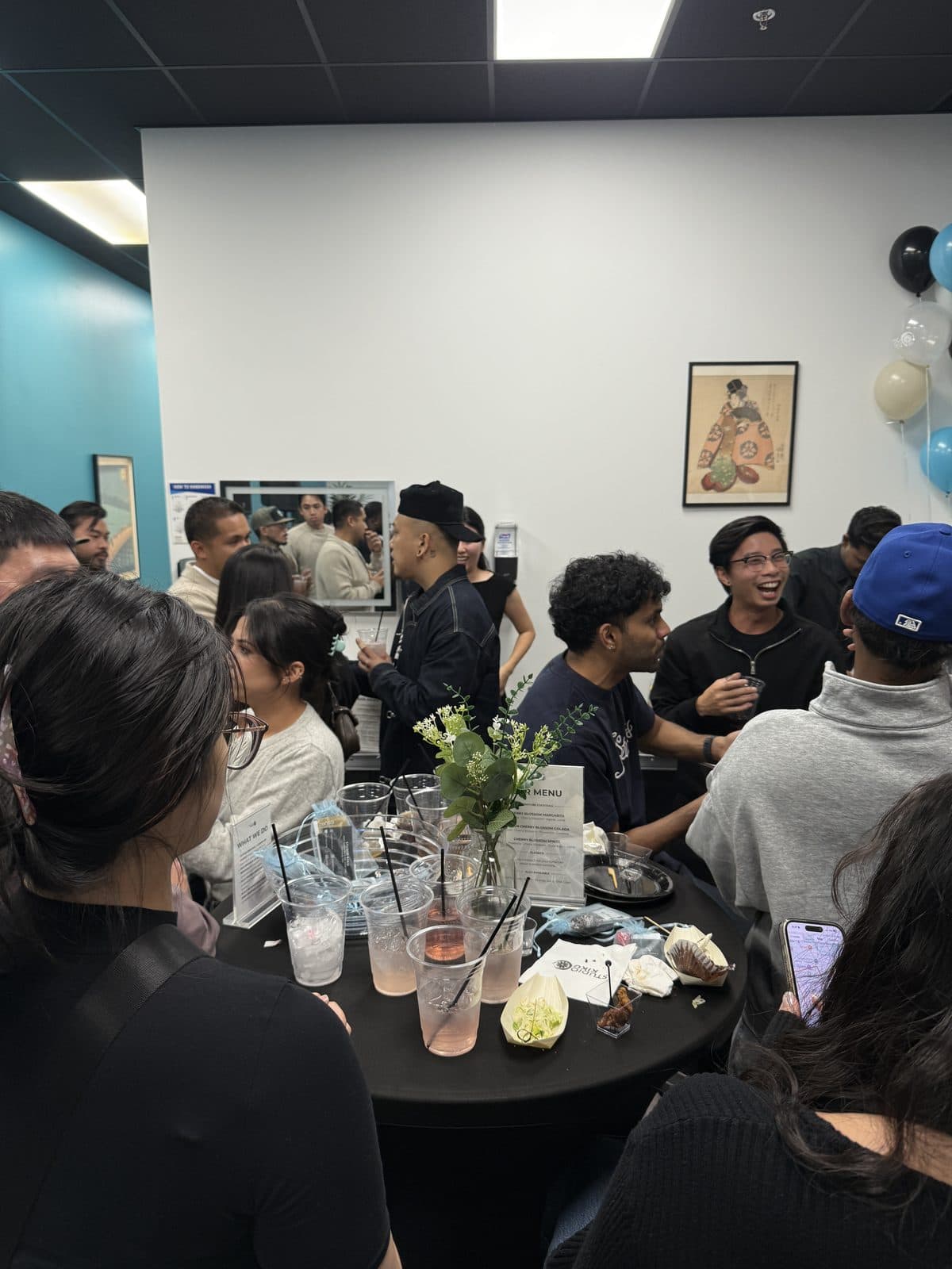 Guests filling the studio around a high table during the evening
