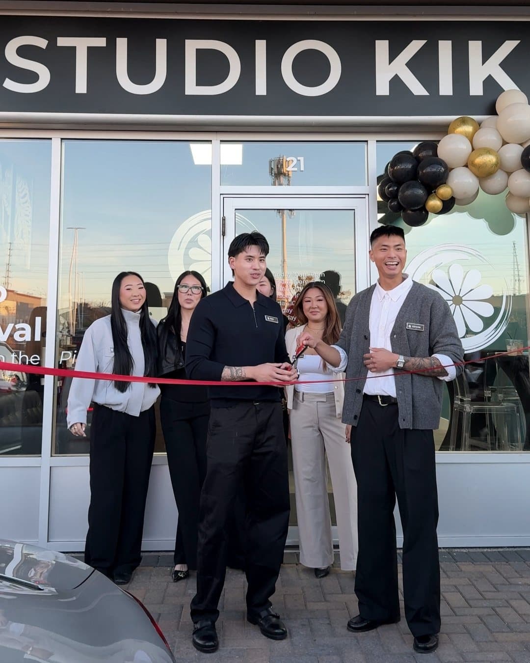 The Vaughan team cutting a red ribbon at the front door of Unit 21 on October 18