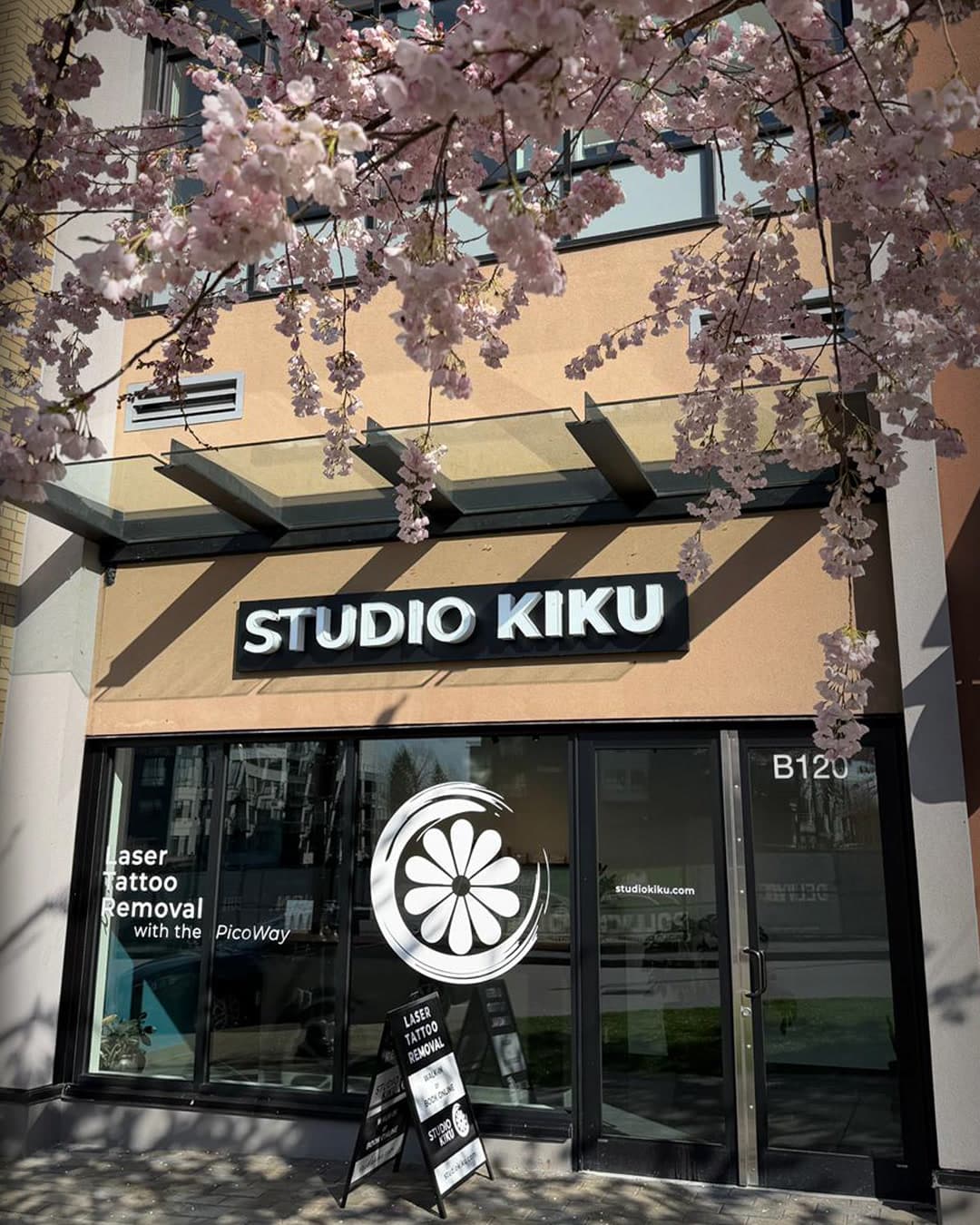 Studio Kiku storefront framed by cherry blossoms