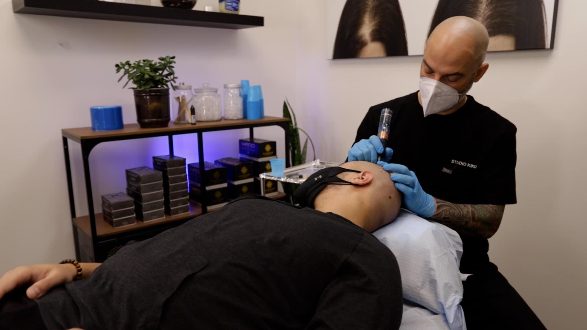 Billy DeCola performing scalp micropigmentation on a client at Studio Kiku