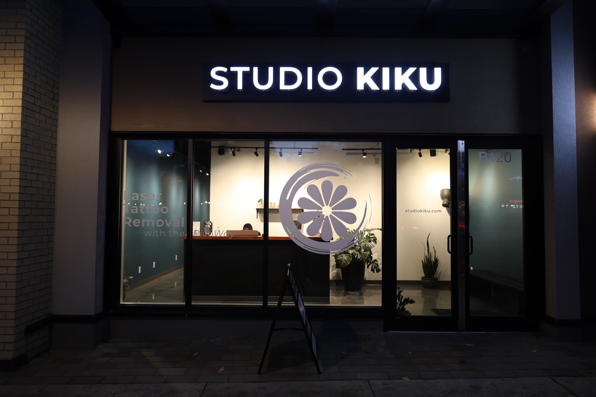 The Studio Kiku Langley storefront at Willoughby Town Centre, lit at night